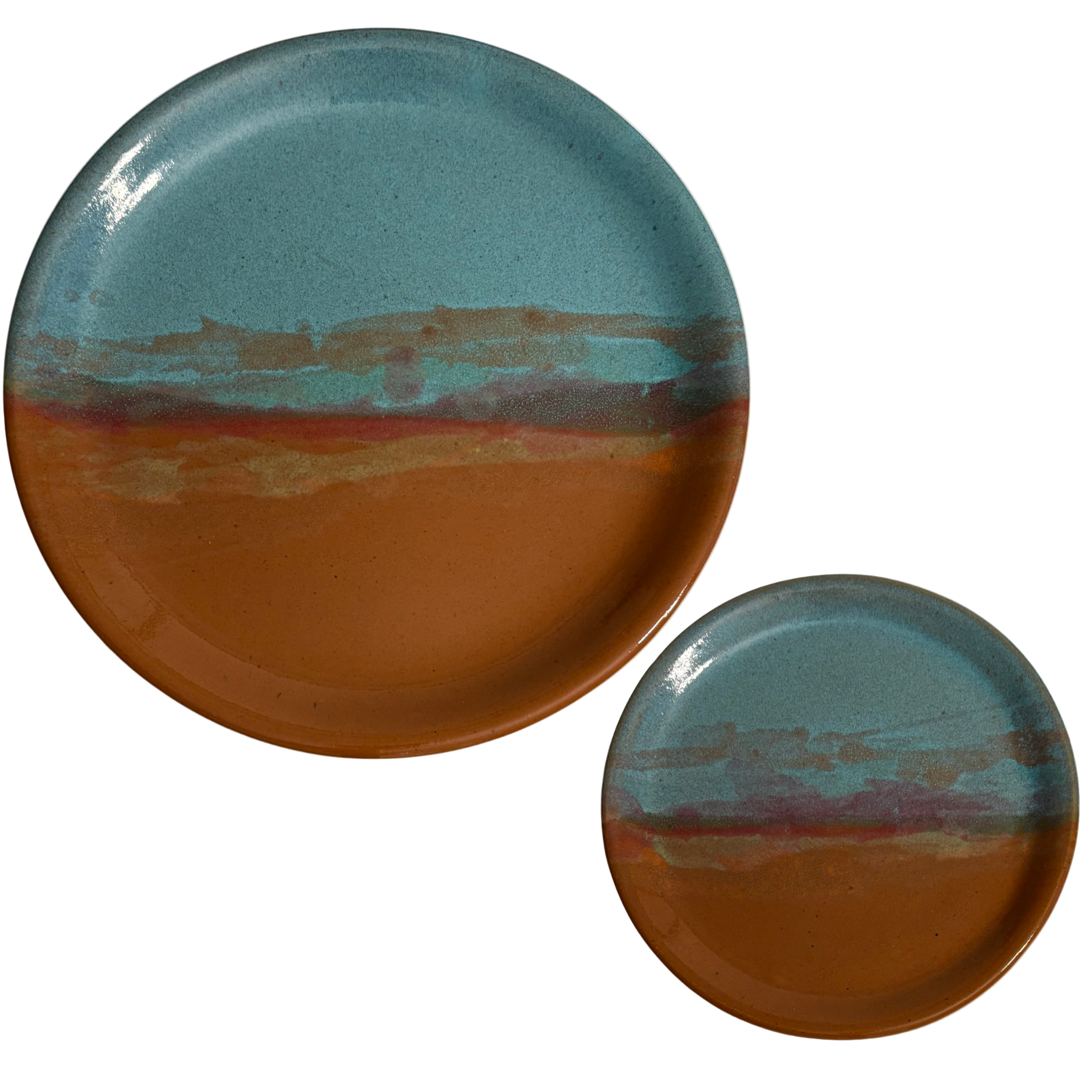 Handmade ceramic dinner & salad plates with blue and rust glaze featuring desert sunset landscape.