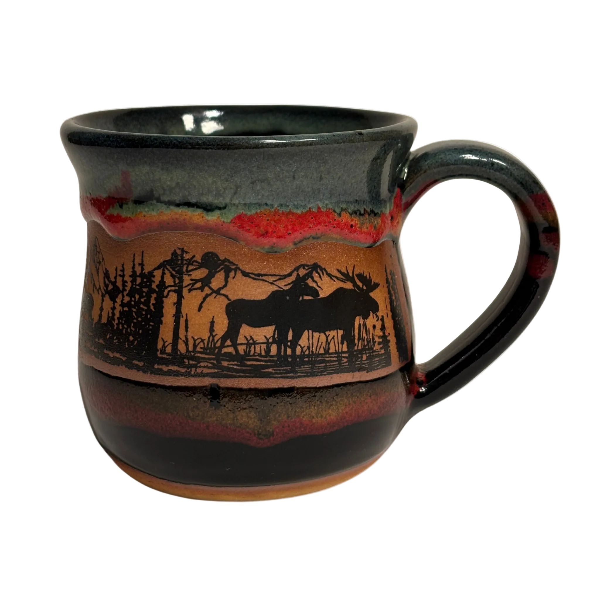 Handmade ceramic mug with moose and pine forest silhouette and layered glaze - representation of Canadian Rockies
