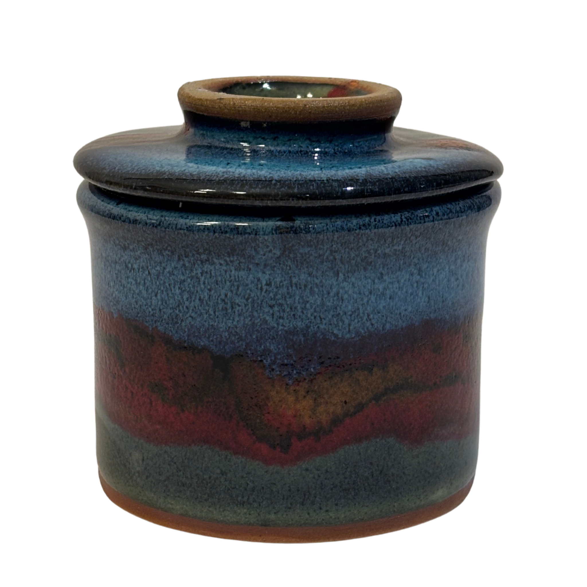 Handmade ceramic French butter press in Artic Twilight glaze with deep blue, red, and earthy tones.