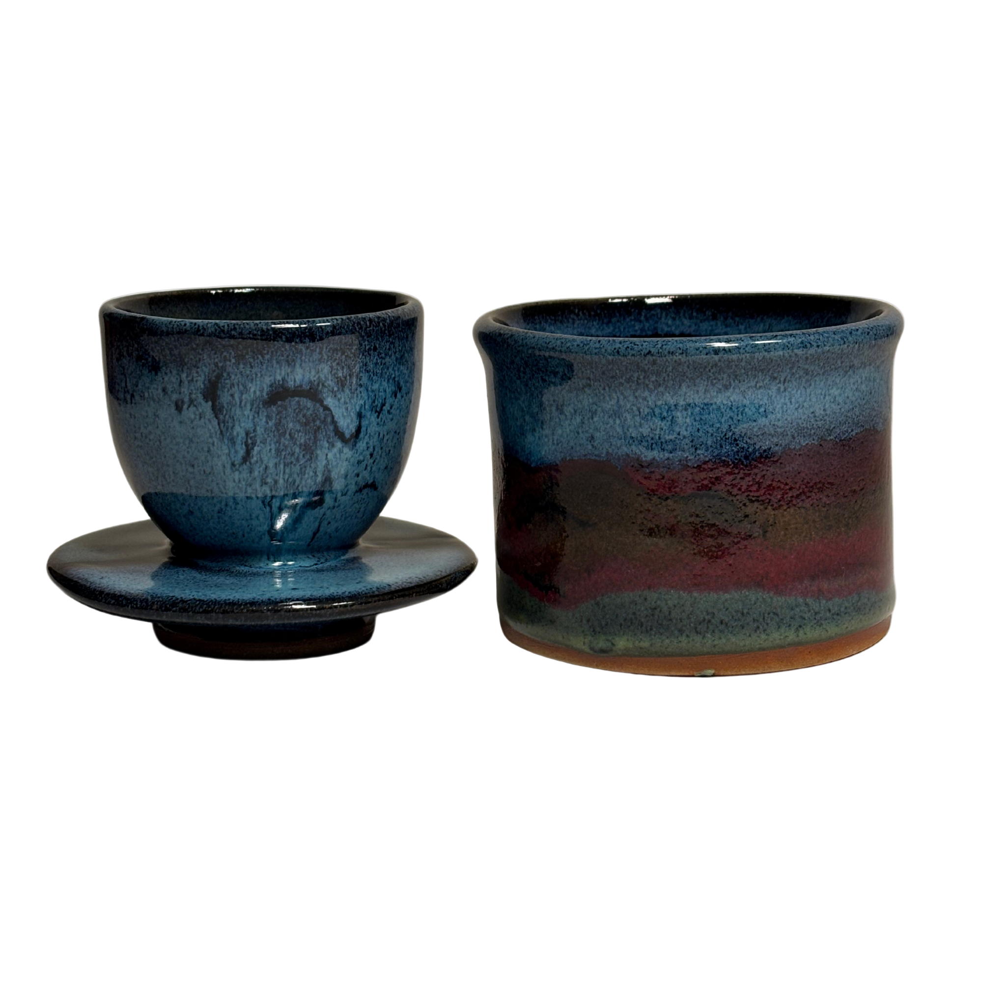 Handmade ceramic French butter keeper with blue, green, and red glaze; base upright and lid on its side showing interior butter compartment.