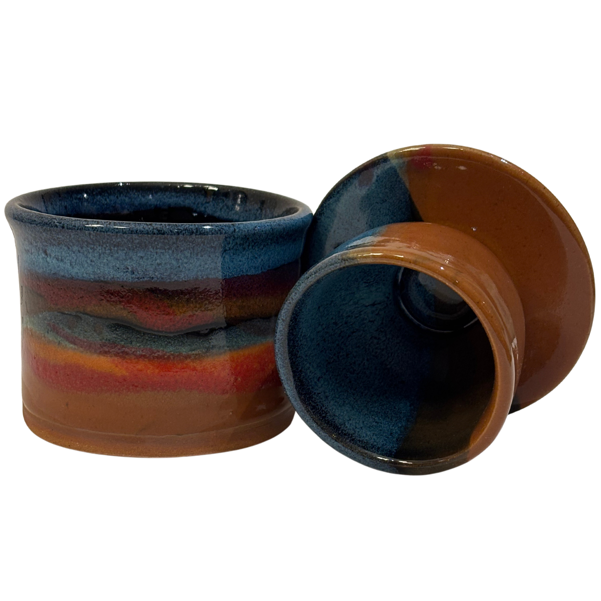 Handmade ceramic French butter press in ruins glaze with blue, red, and earthy brown tones