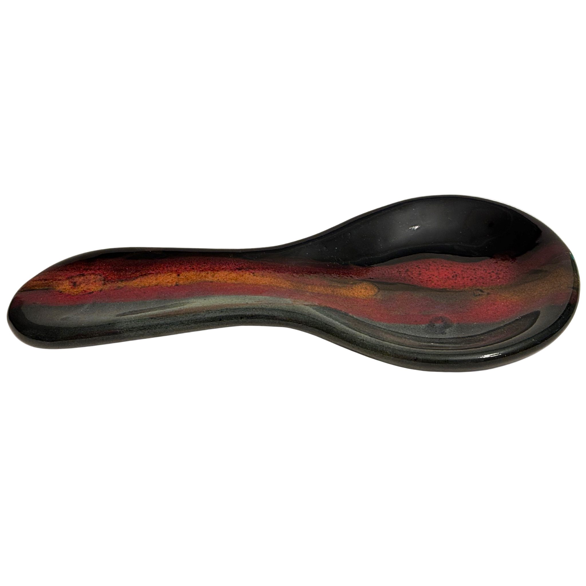 Handmade Jasper Wilderness ceramic spoon rest for kitchen counters, with black glaze, earthy red, and golden tones inspired by mountain sunsets.