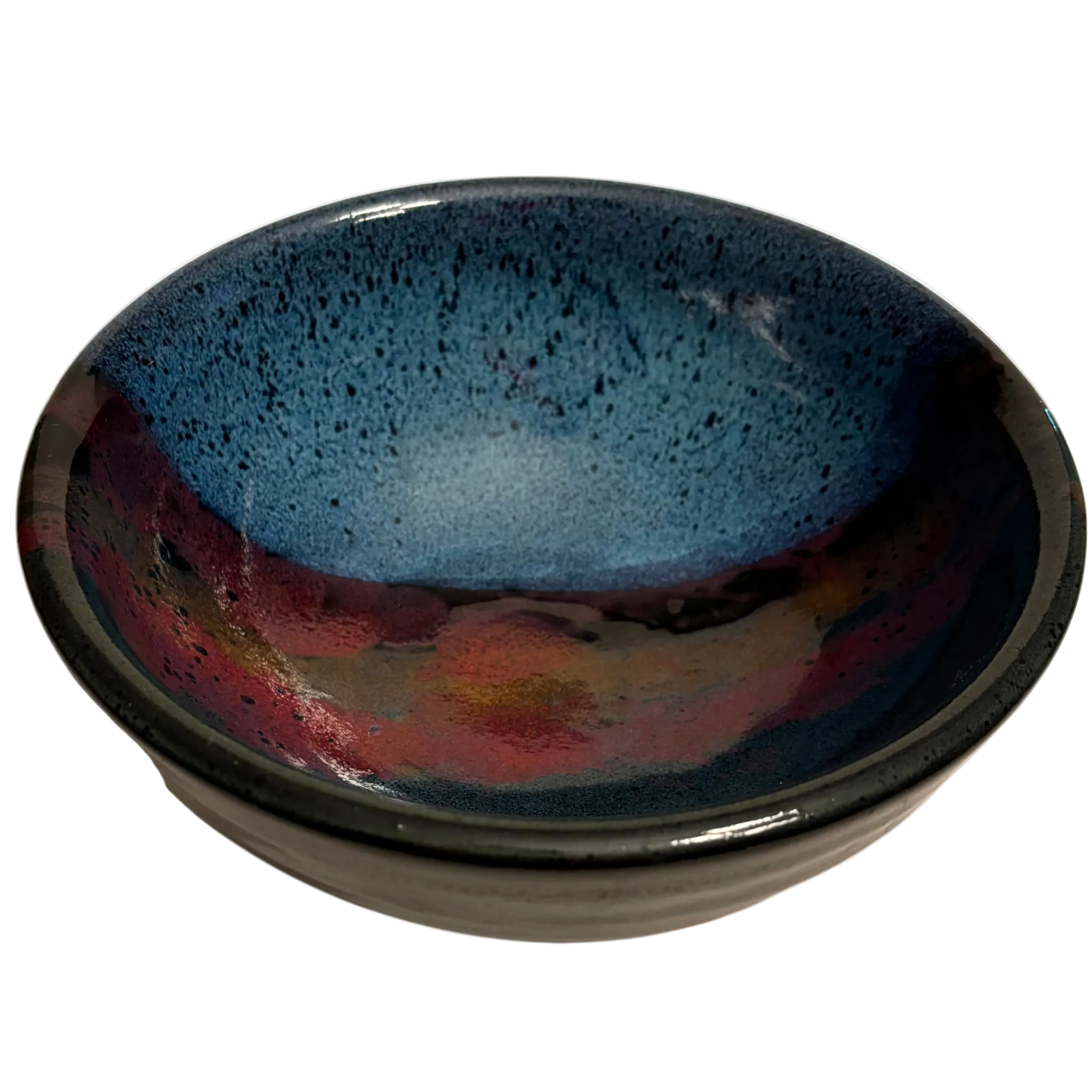 Mountain Dusk handmade ceramic salad bowl with deep blue interior and flowing red, brown, and purple glaze resembling dusk sky.