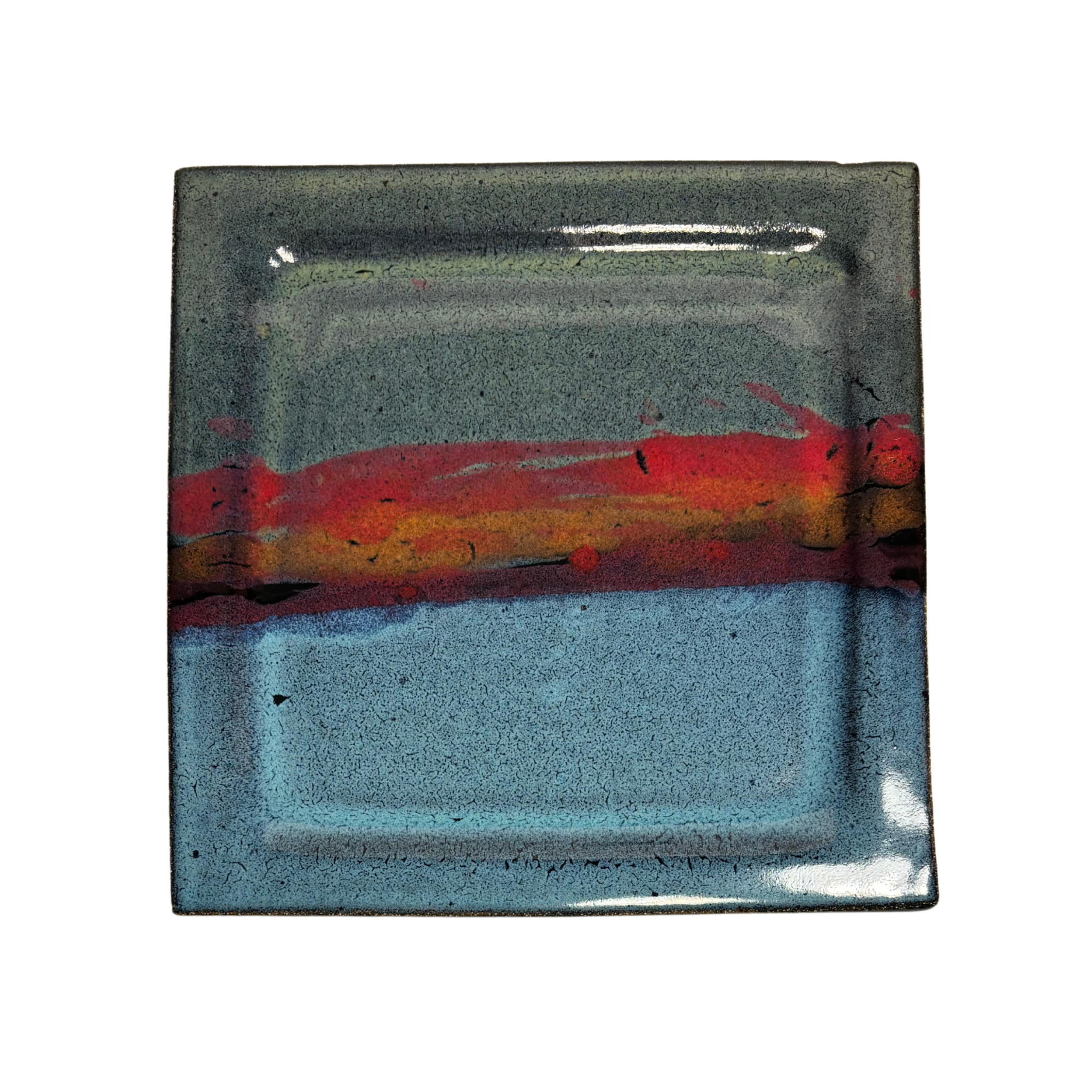 Handcrafted square ceramic dinner plate with layered glaze in blue, red, and black tones – artisan pottery tableware with modern rustic finish.