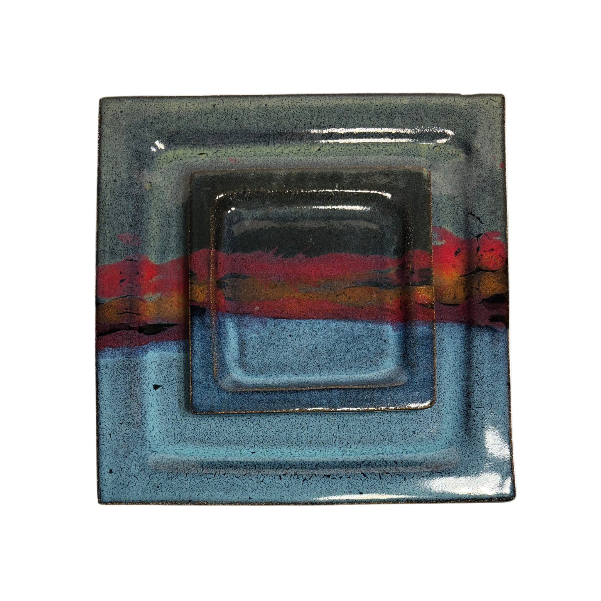 Handcrafted square ceramic dinner and salad plate set with layered glaze in blue, red, and black tones – artisan pottery tableware with modern rustic finish.