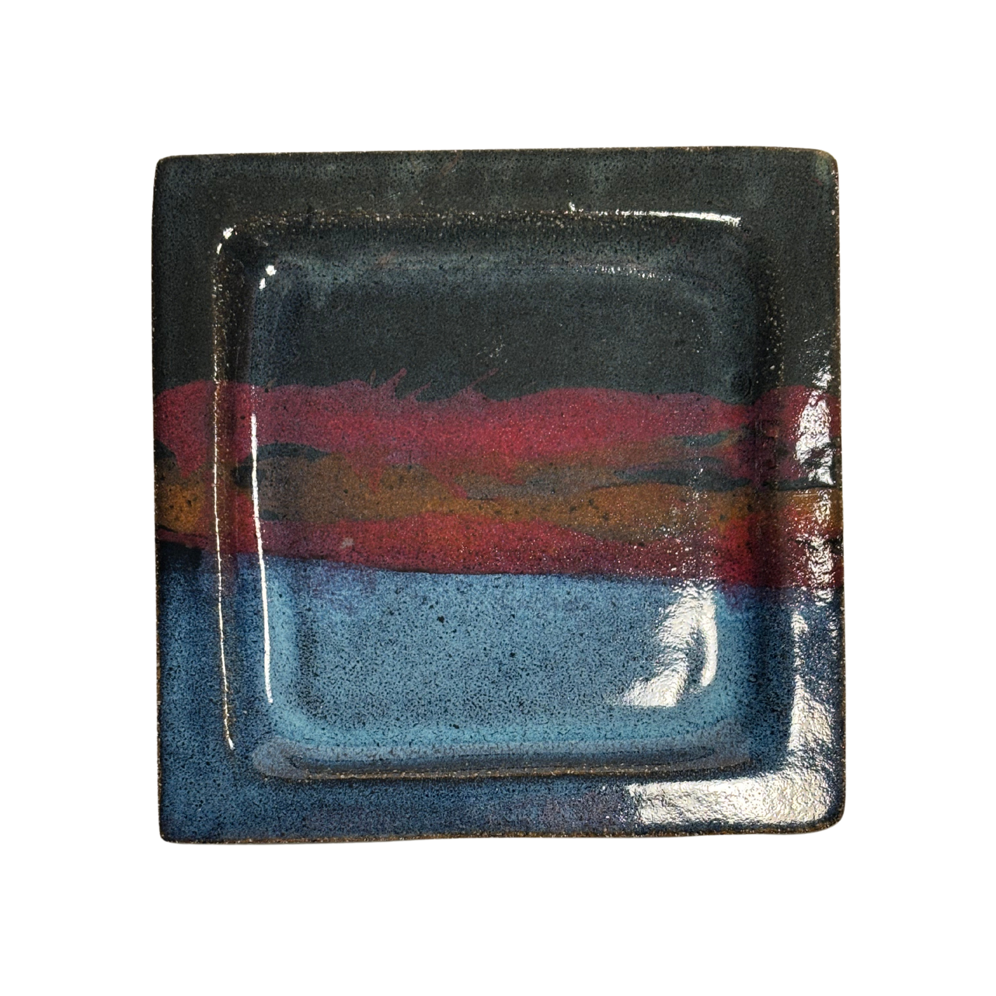 Handcrafted square ceramic salad plate set with layered glaze in blue, red, and black tones – artisan pottery tableware with modern rustic finish.
