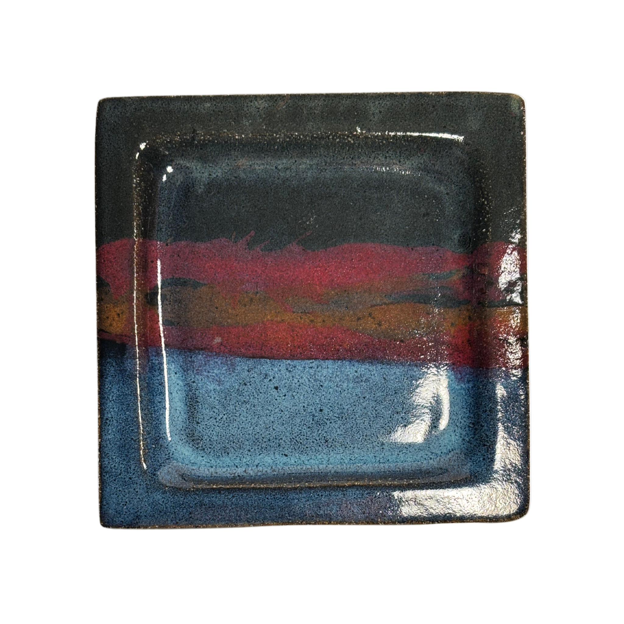 Handcrafted square ceramic salad plate set with layered glaze in blue, red, and black tones – artisan pottery tableware with modern rustic finish.