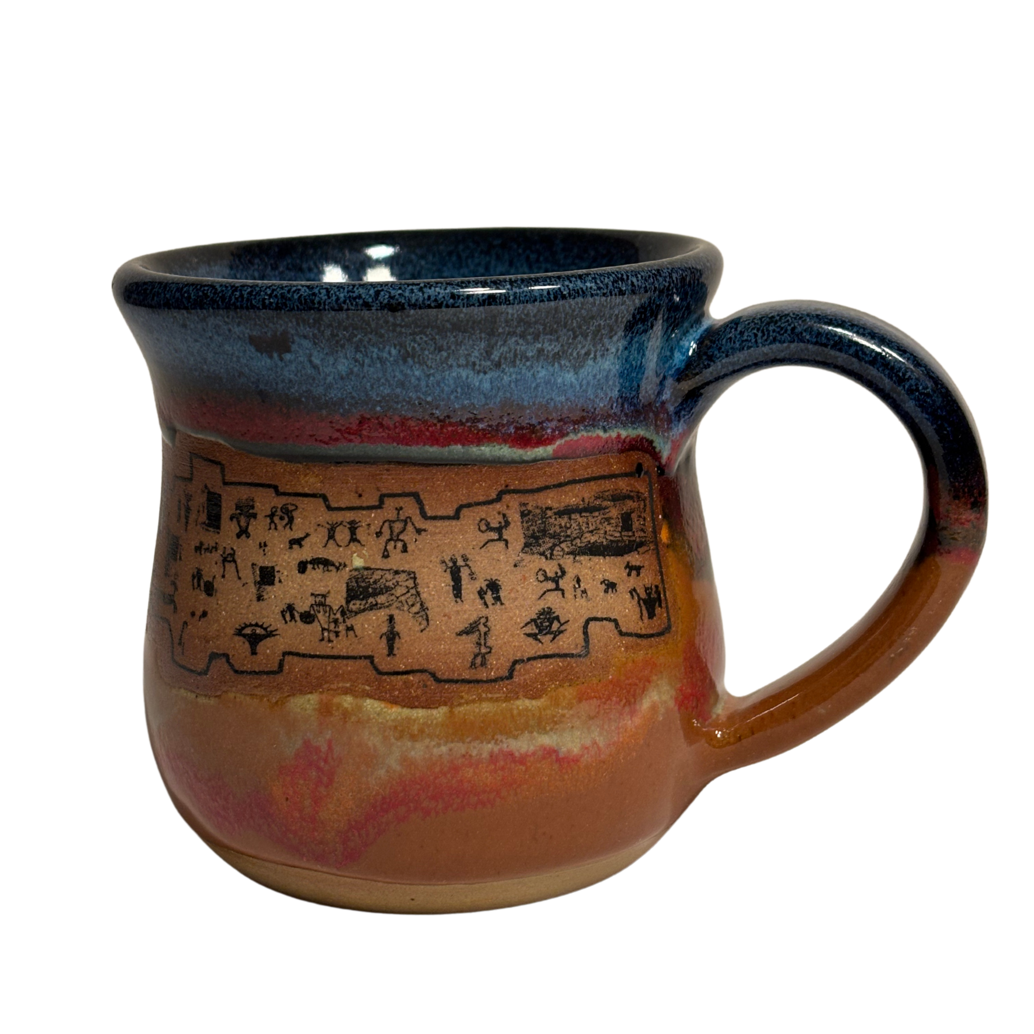Handmade ceramic mug with ancient petroglyph-style artwork and deep desert glaze