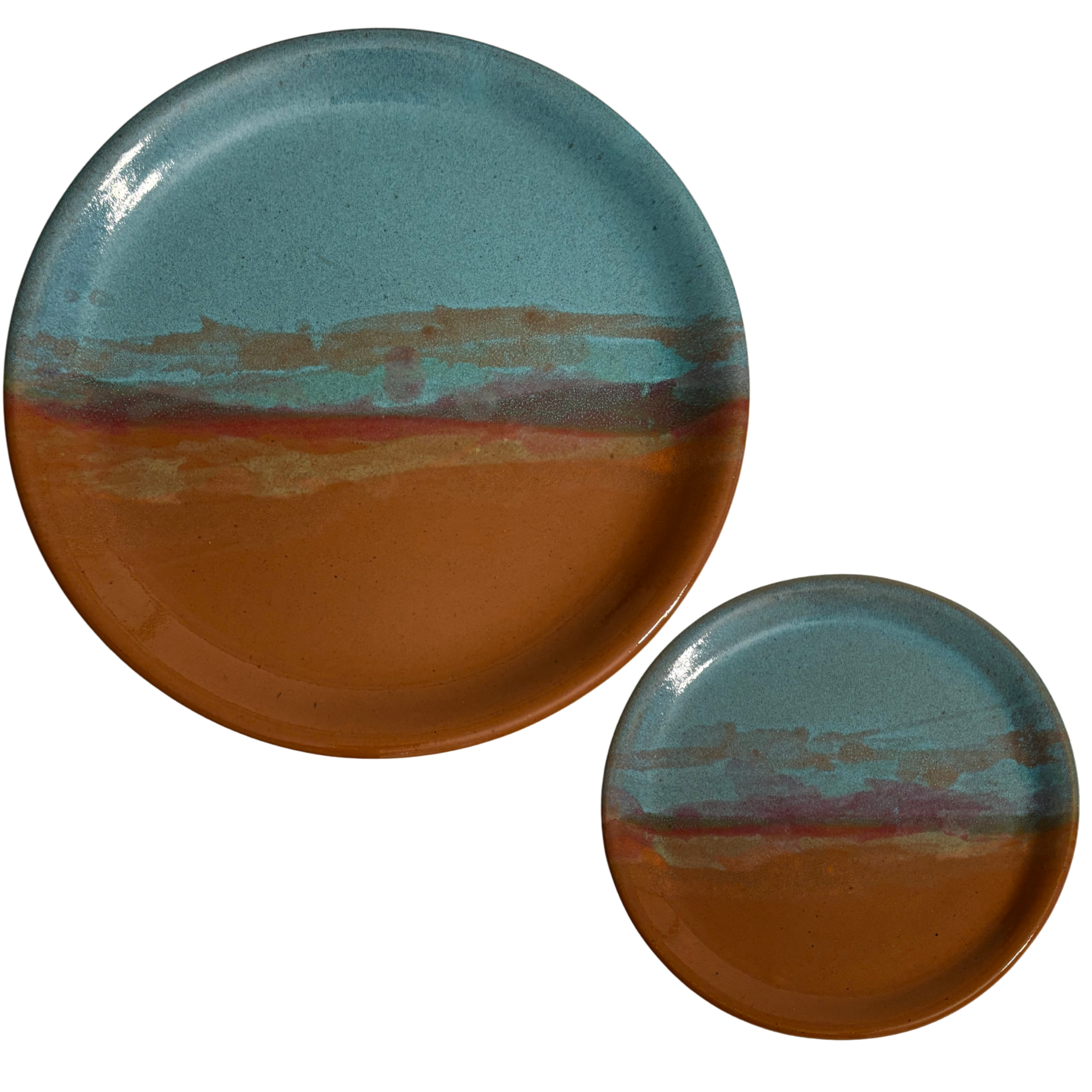 Handmade ceramic dinner & salad plates with blue and rust glaze featuring desert sunset landscape.