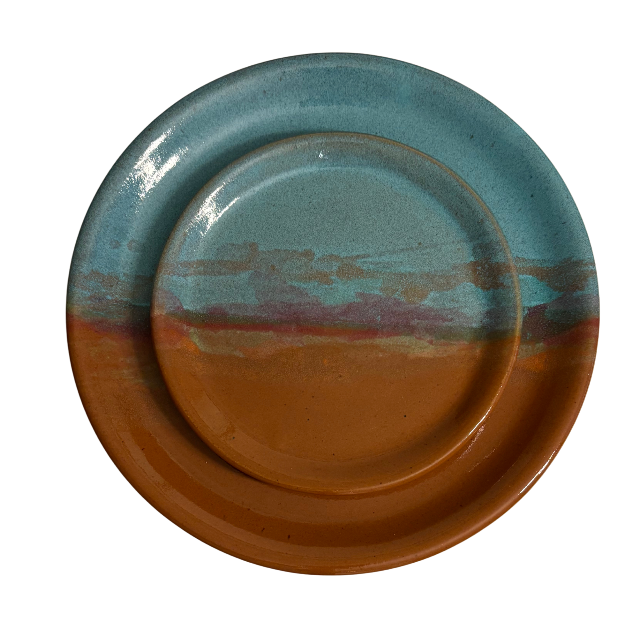 Handmade ceramic dinner & salad plates with blue and rust glaze featuring desert sunset landscape.