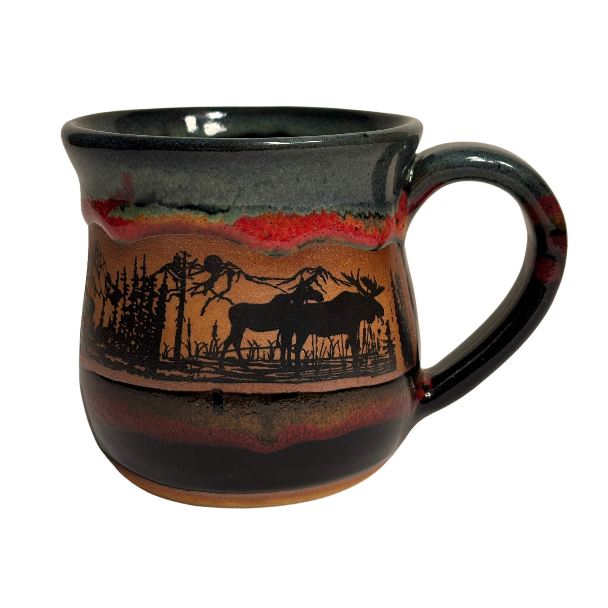 Handmade ceramic mug with moose and pine forest silhouette and layered glaze - representation of Canadian Rockies
