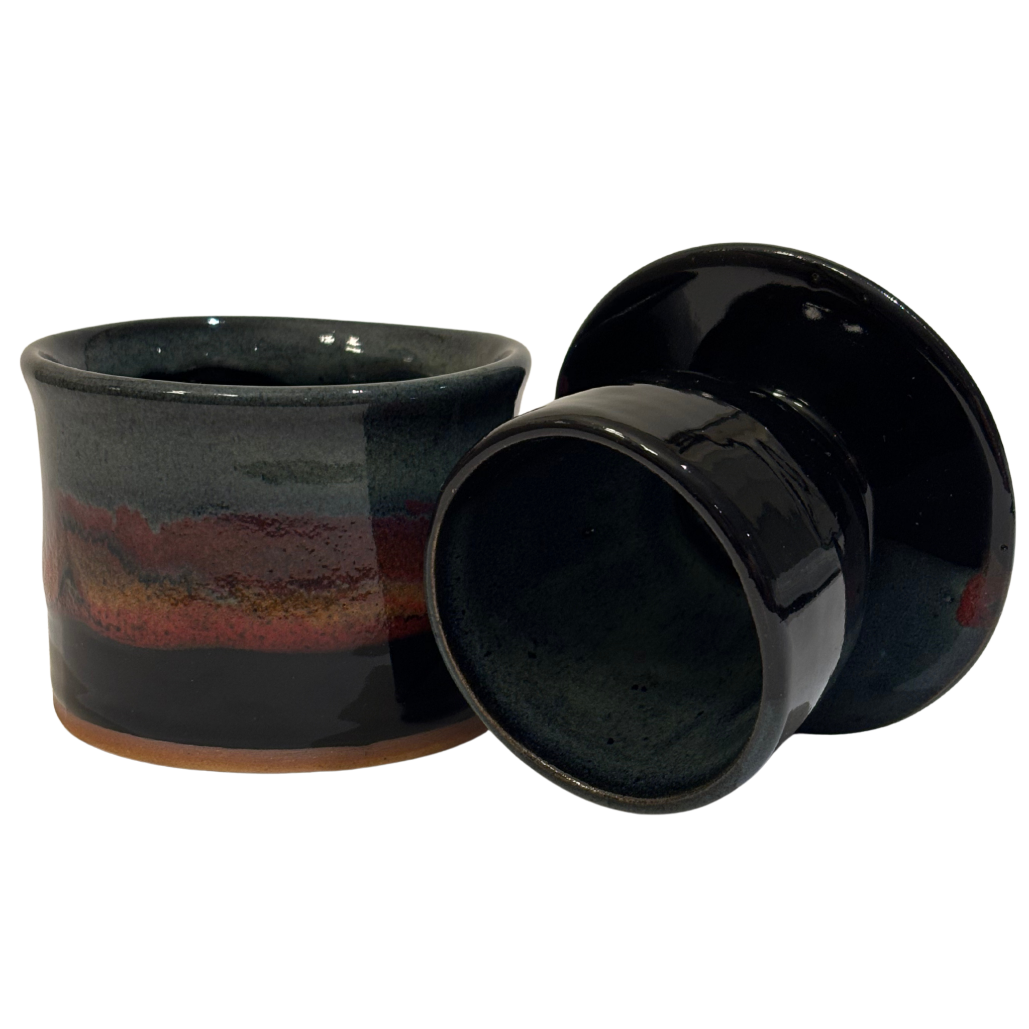 Handmade ceramic French butter press in Mountain Dusk glaze with green, red, and black tones