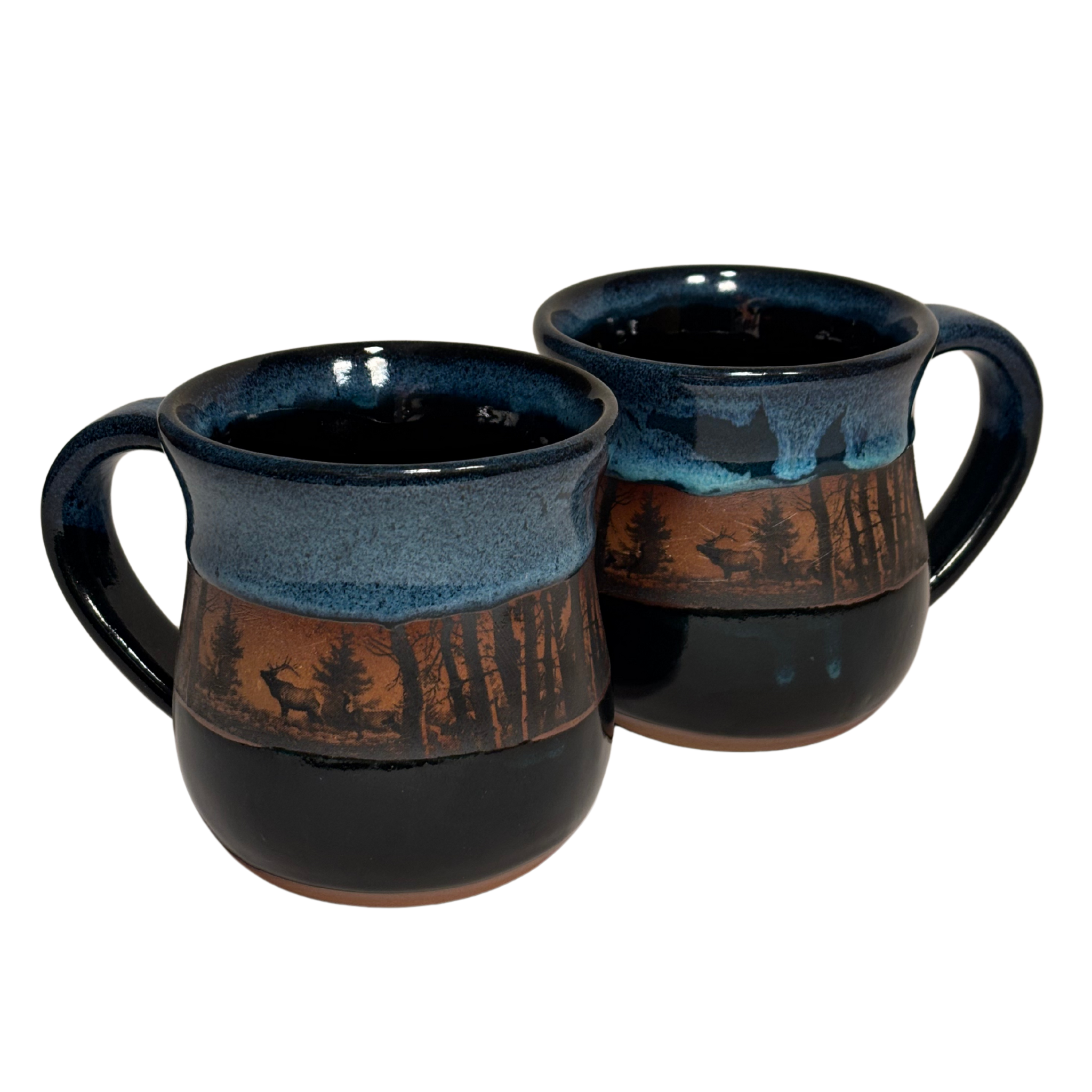 Handmade ceramic mug with forest and elk silhouette under layered mountain glaze. representation of Canadian Rockies.