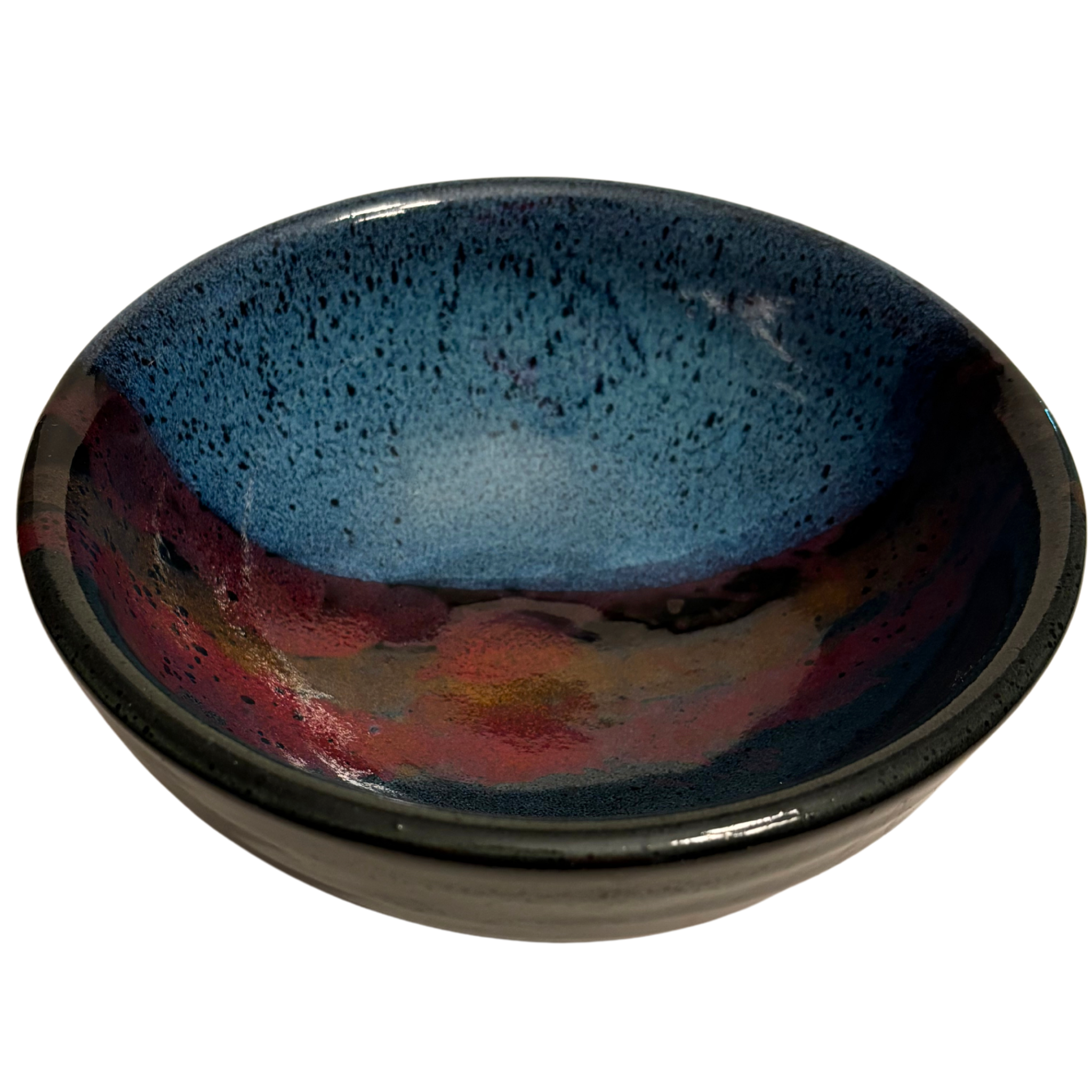 Mountain Dusk handmade ceramic salad bowl with deep blue interior and flowing red, brown, and purple glaze resembling dusk sky.