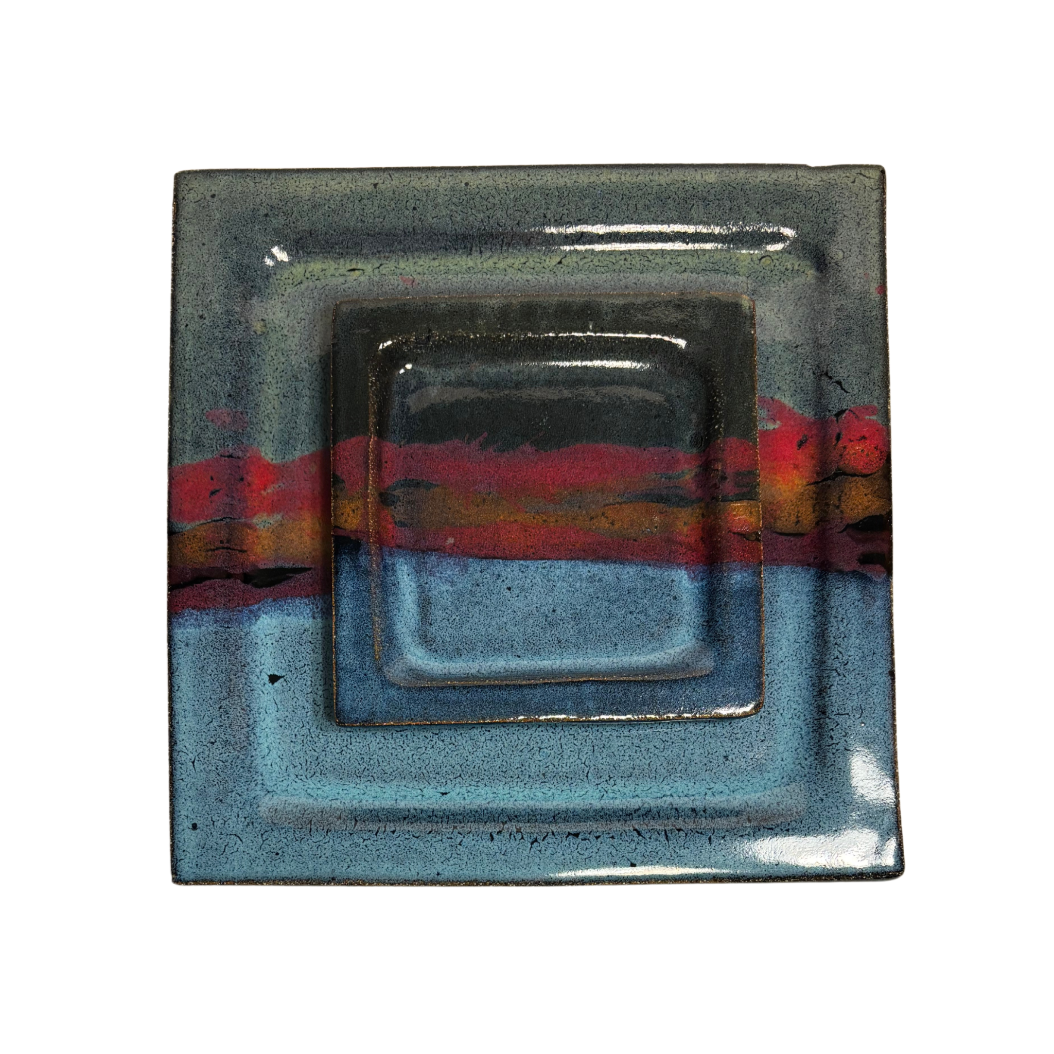 Handcrafted square ceramic dinner and salad plate set with layered glaze in blue, red, and black tones – artisan pottery tableware with modern rustic finish.
